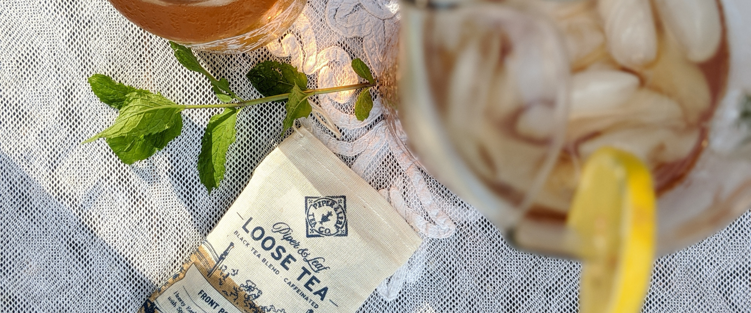 Piper & Leaf front porch special next to a pitcher of iced front porch special tea with a lemon on the rim 